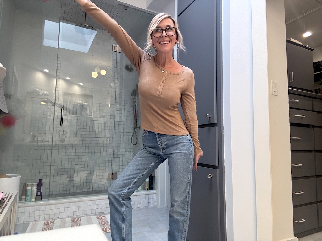 Collin wearing Henley top and jeans in bathroom 