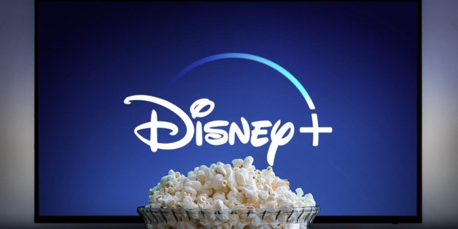 disney plus on tv with bowl of popcorn in front of it 