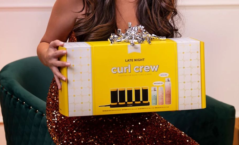 woman holding a boxed hot roller gift set