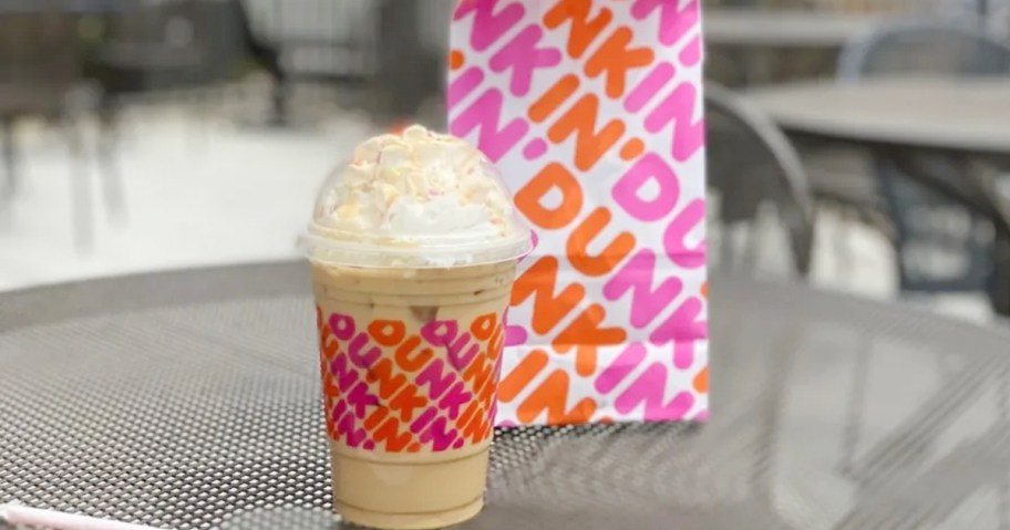 dunkin donuts drink and bag on table