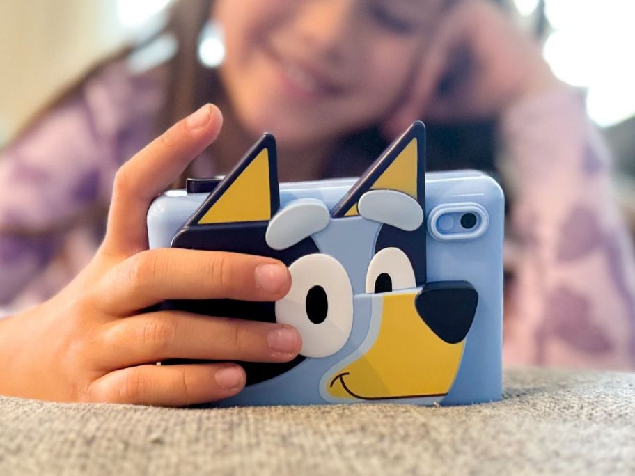 A girl playing with an eKids Bluey Digital Camera