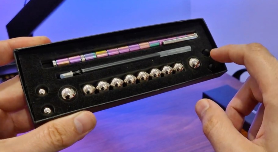 hands holding fidget pen box