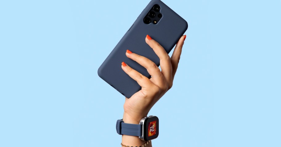 hand holding watch and blue phone