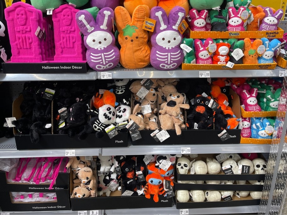 assorted halloween themed plush toys in different sizes on store shelf