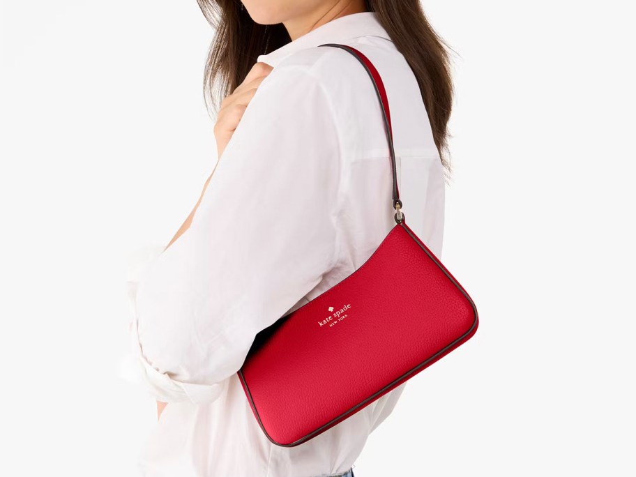 woman wearing red kate spade bag 