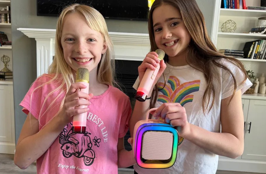 two girls with a rainbow karaoke machine