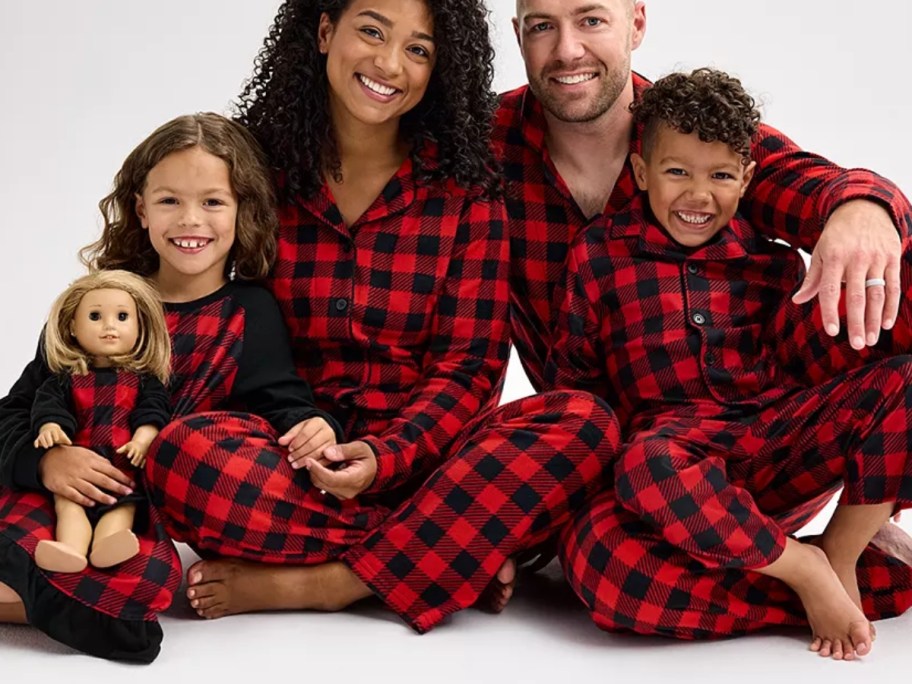 mom dad, little girl, and little boy wearing matching red and black buffalo plaid pajamas