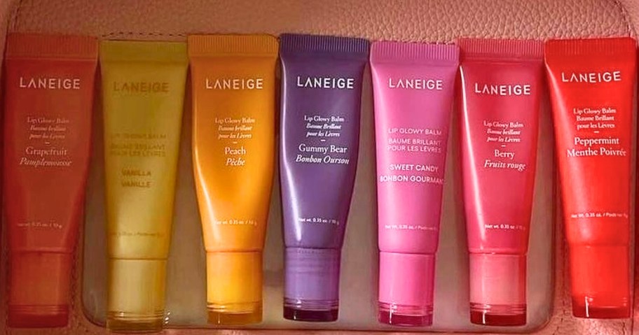 several Laneige Glowy Lip Balm tubes in different colors and flavors inside a makeup bag