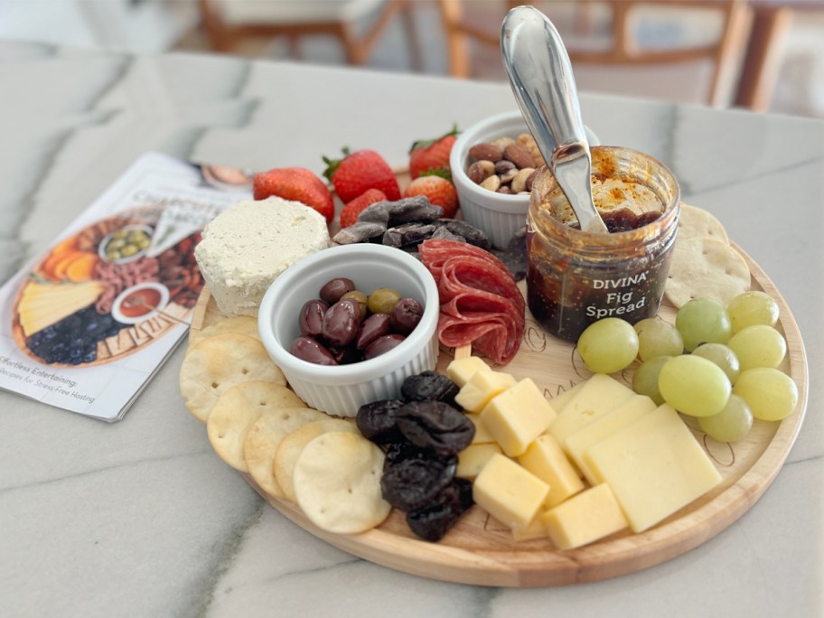 charcuterie board with cheese and meats on it on countertop 