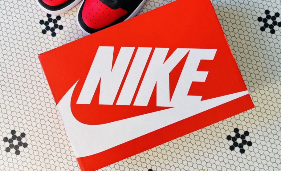 nike box on the floor next to jordans