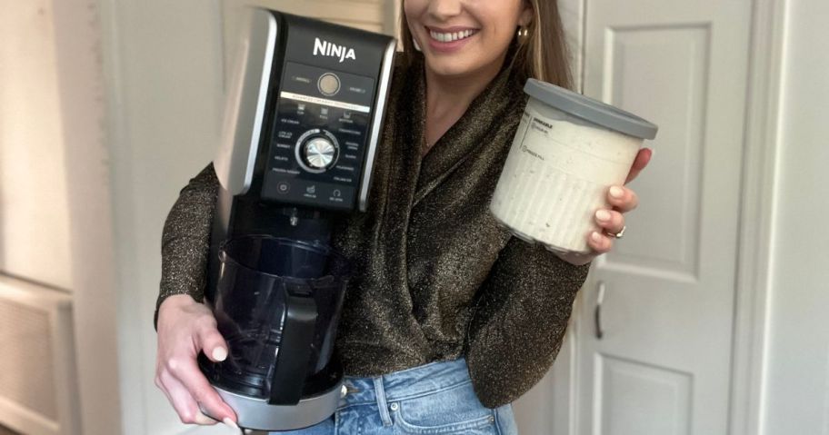 girl holding Ninja CREAMi 7-in-1 Frozen Treat Maker with Extra Pints