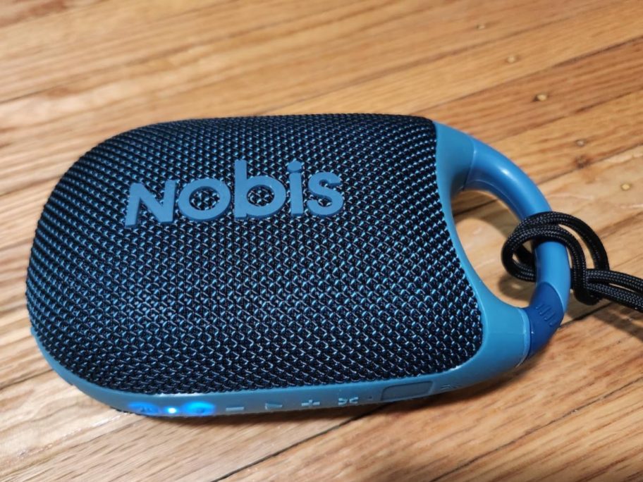 blue nobis clip speaker on wood table