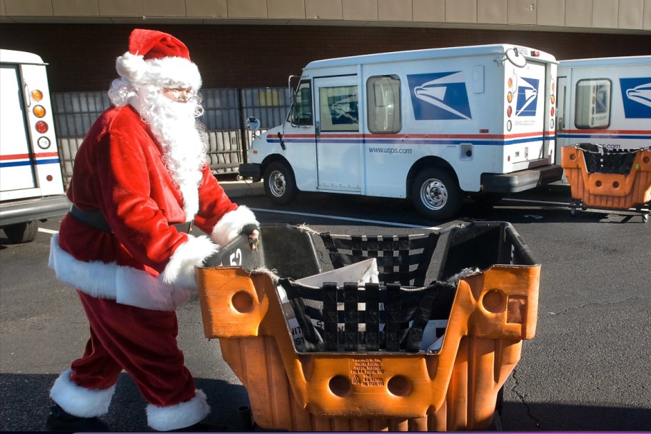 santa pushing mail cart