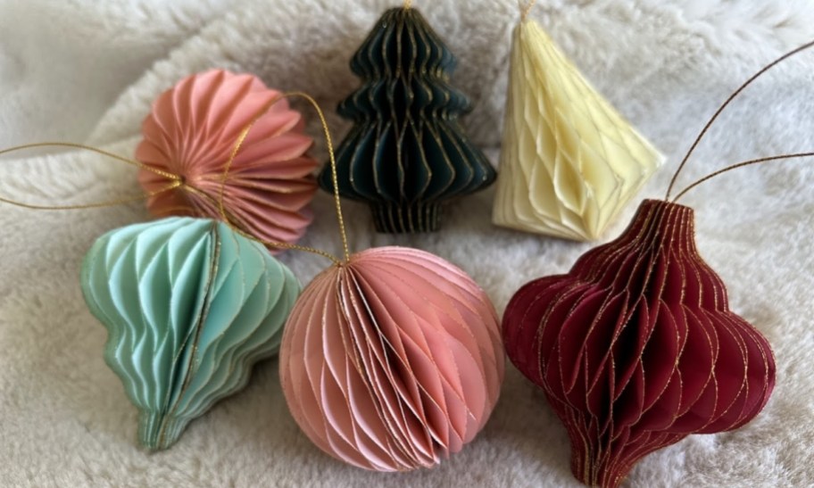 paper christmas tree ornaments displayed on a faux fur blanket