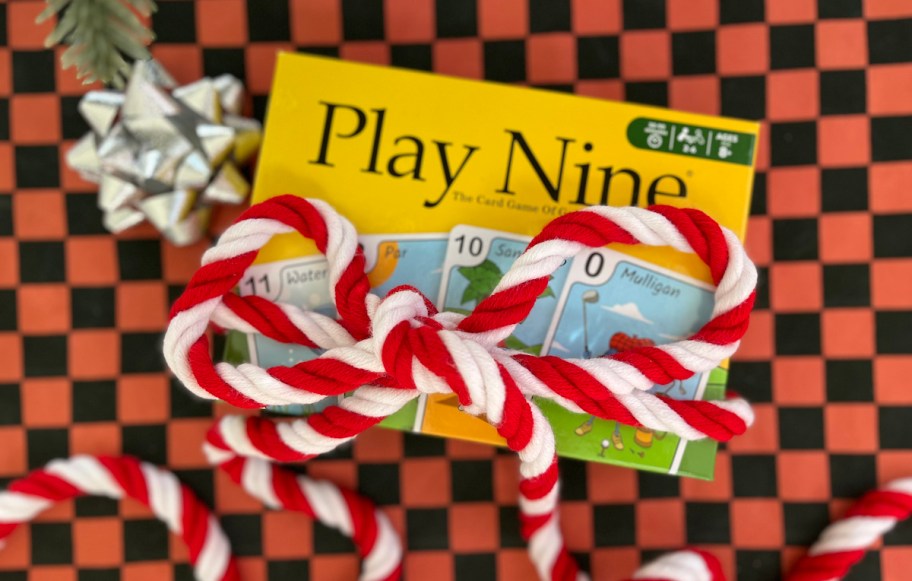 play nine card game wrapped in red and white ribbon