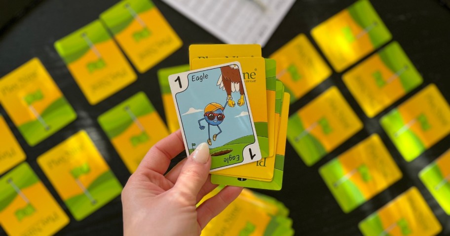 hand holding Play Nine game cards