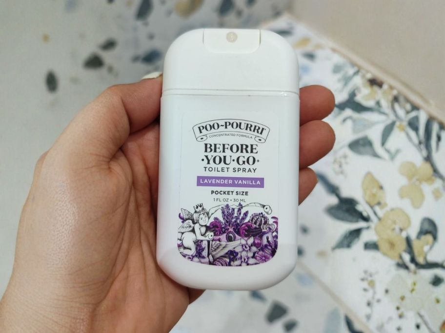 hand holding Poo-Pourri Spray