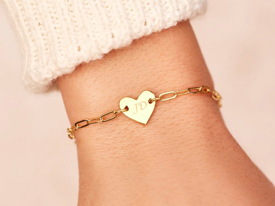 person wearing heart bracelet