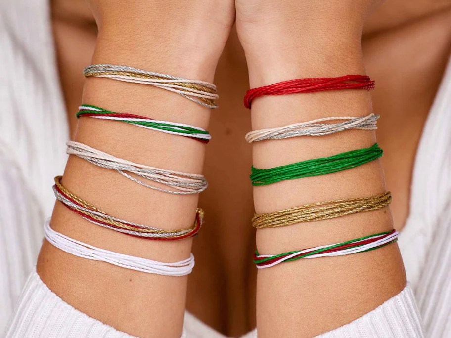 person wearing 10 holiday bracelets