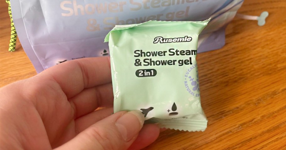 hand holding shower steamer packet 