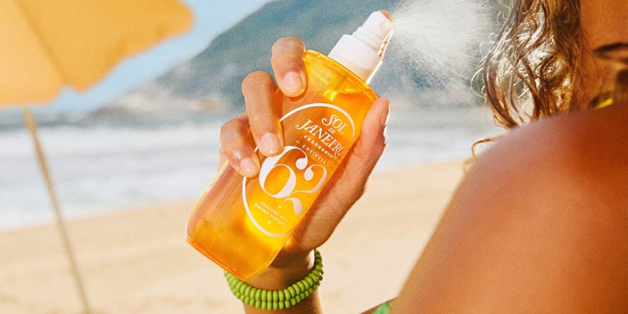 woman holding sol de janeiro mist 