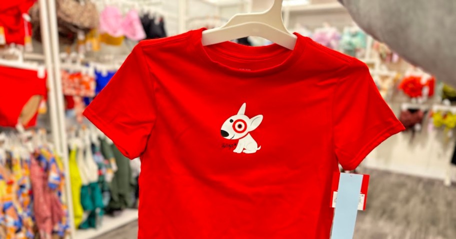 person holding up a red target bullseye t-shirt on a hanger