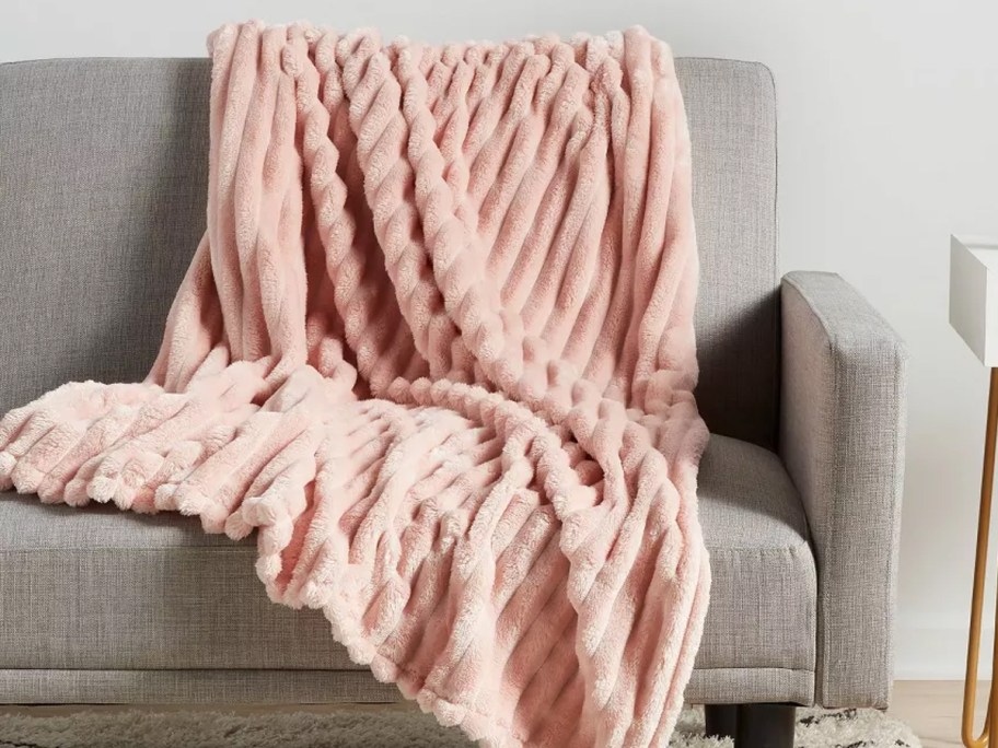 pink blanket on gray couch