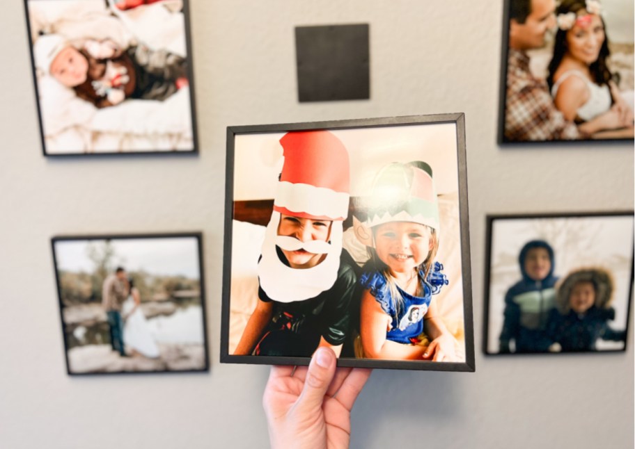 hand placing tilepix on wall