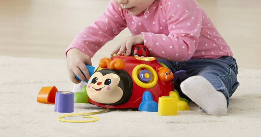 baby playing with vtech learning bug toy 