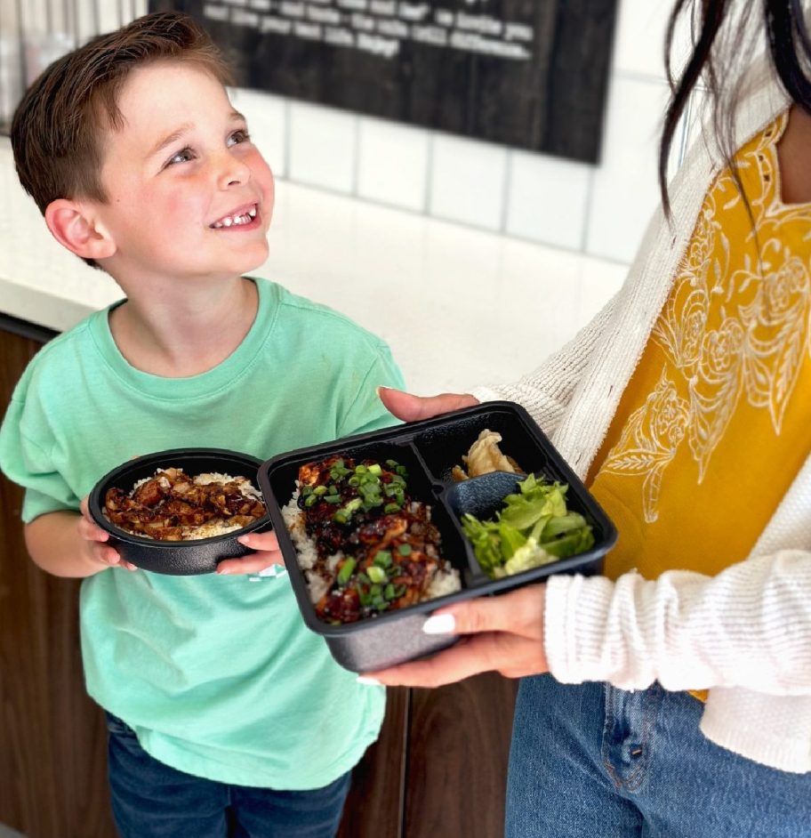 mother and child taking advantage of the kids eat free bowl at Waba Grill