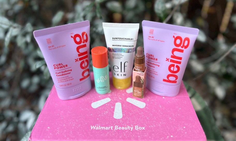 walmart beauty box with mini products on top sitting in front of flocked christmas tree