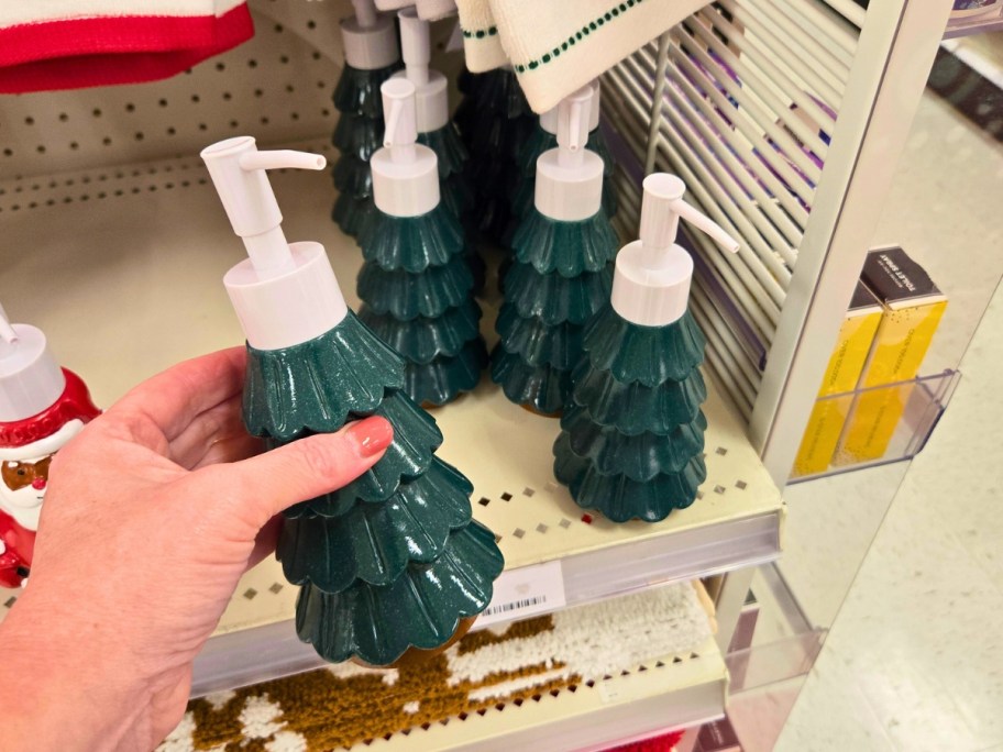 hand holding a Christmas Tree shaped soap pump on a store shelf