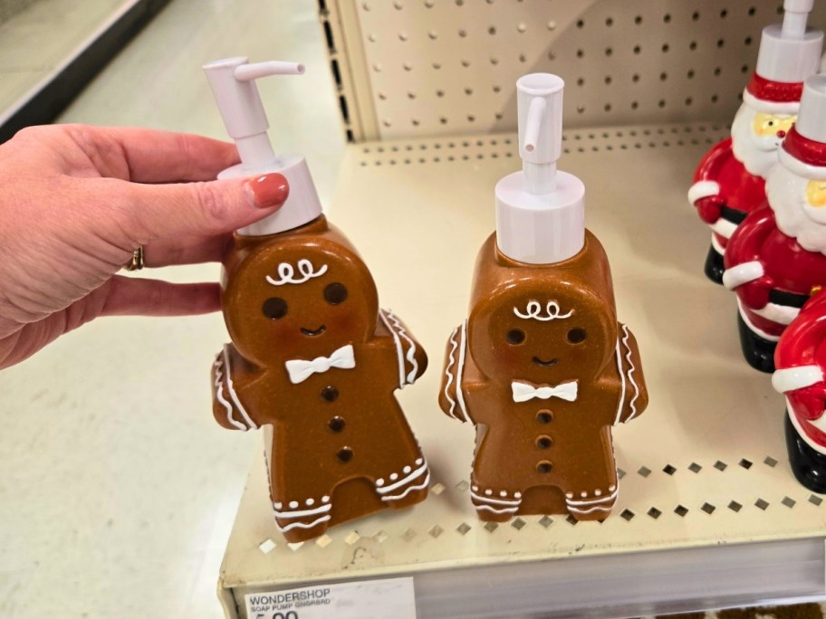 hand on a Gingerbread man shaped soap pump on a store shelf