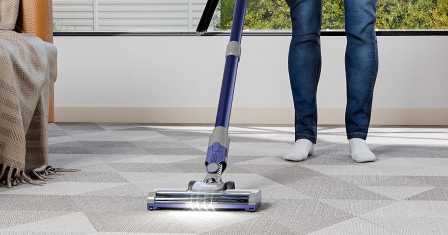 person vacuuming the carpet