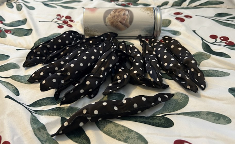 black and white polka dot satin hair rollers on bed