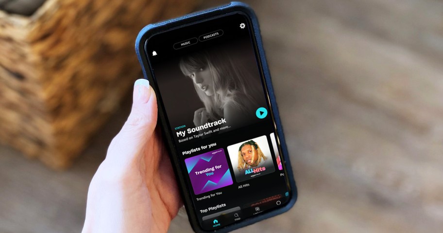 hand holding an iPhone with the Amazon Music Unlimited app open