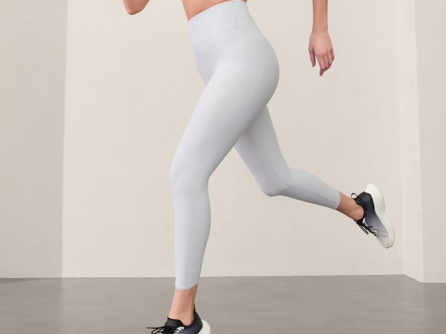 woman wearing Athleta Pacesetter Ultra High Rise 7/8 Leggings