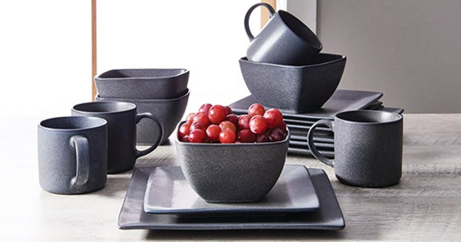 set of black square plates, bowls, and mugs on table