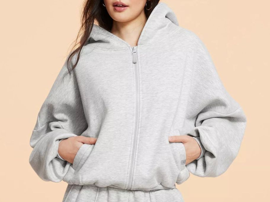 woman wearing a Blogilates Women's Marshmallow Full Zip Hooded Sweatshirt