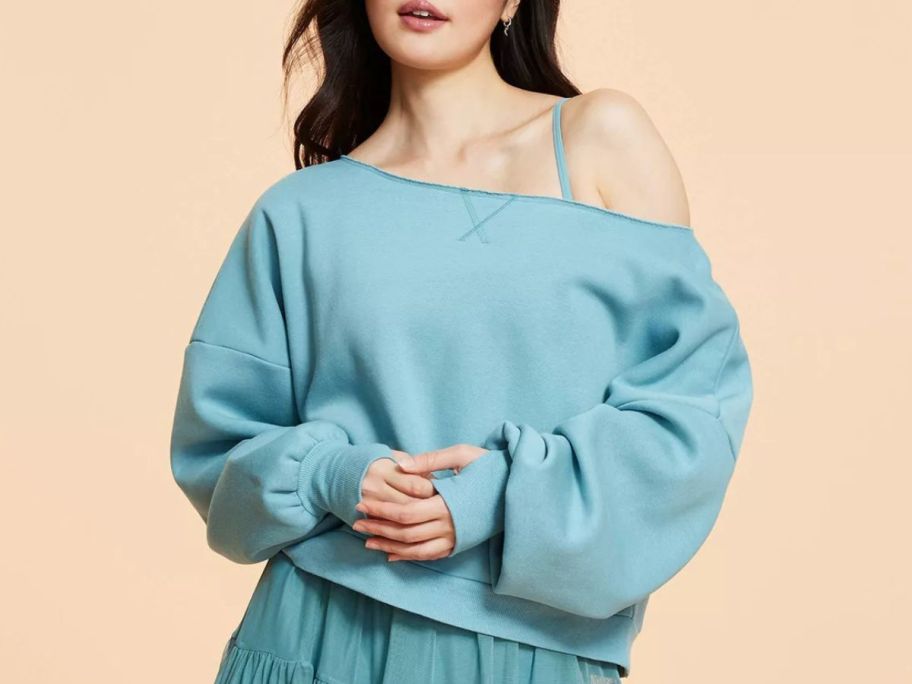 Woman wearing a Blogilates off the shoulder sweatshirt