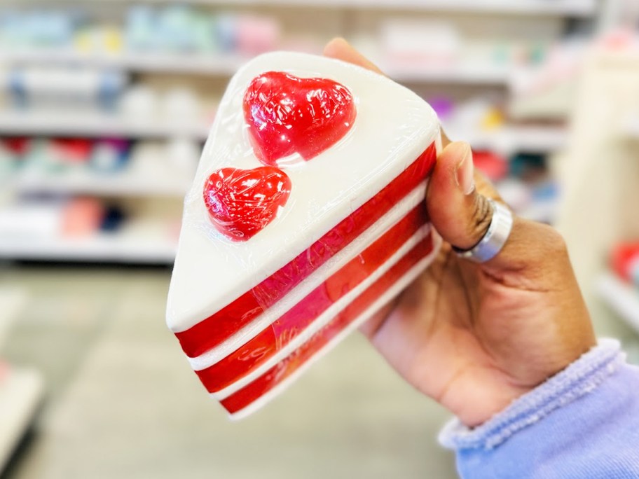 hand holding a trinket box shaped as a cake slice