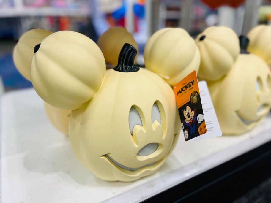 A cream-colored Mickey Mouse head shaped like a pumpkin