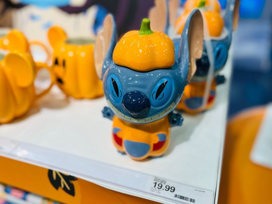A ceramic Stitch dressed like a pumpkin