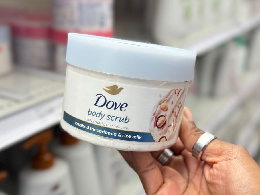 Hand holding up a Dove Body Scrub