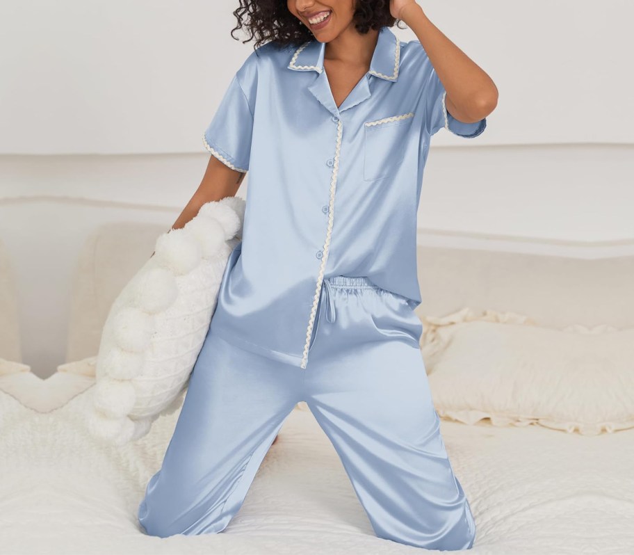 woman on bed in blue silk pajamas