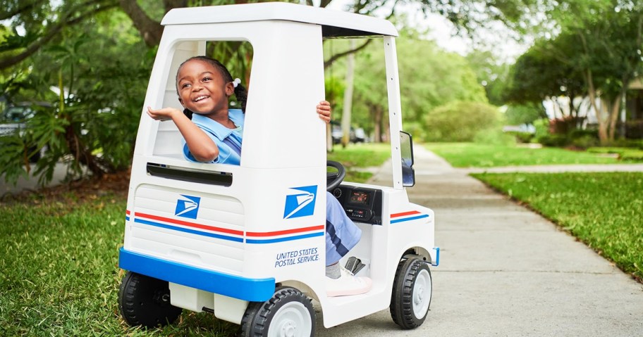 girl waving from a usps ride-on toy