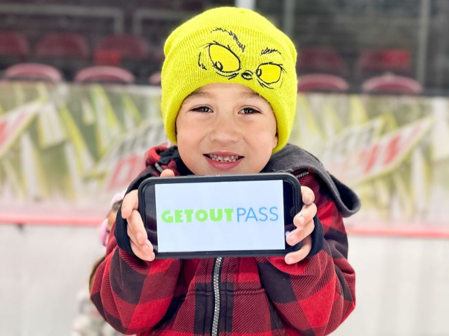 Little boy holding a GetOutPass on a cell phone