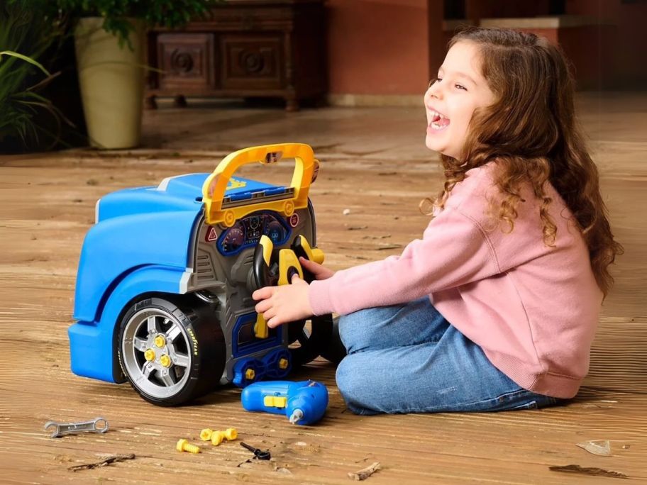 girl playing with Goodyear engine toy