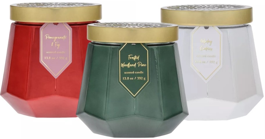 3 glass jar candles with gold lids, one is red, one is green, and one is white - all Christmas scents