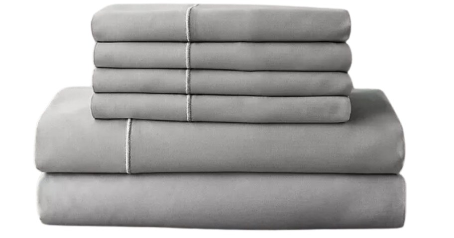 a set of grey luxury high thread count sheets folded and stacked